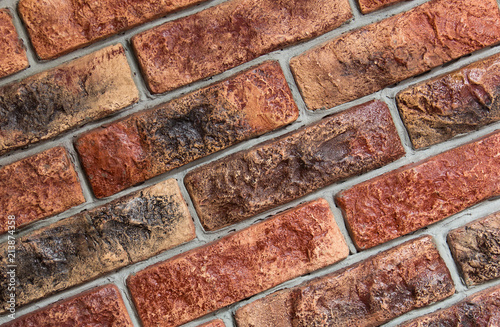 Old red dark rustic bricks on wall photo