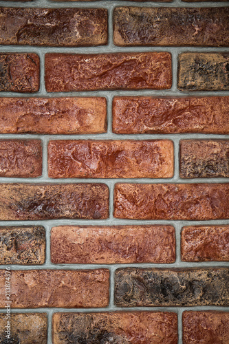 Old red dark rustic bricks on wall photo