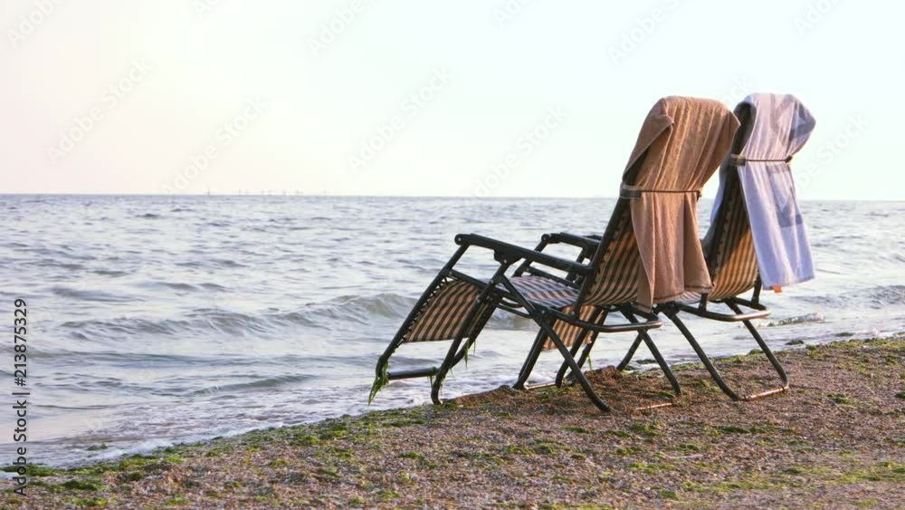Deck beach chairs on seashore. Sea romantic concept. Deck beach chairs on seashore. Sea romantic concept.
