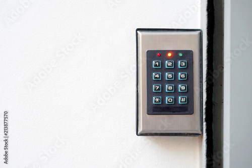 Secure password on keyboard for opening home house door. Password code Security keypad system protected in Public Building. The security code combination to unlock the door