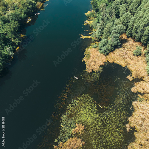 aerial look on small boat in the middle of big river