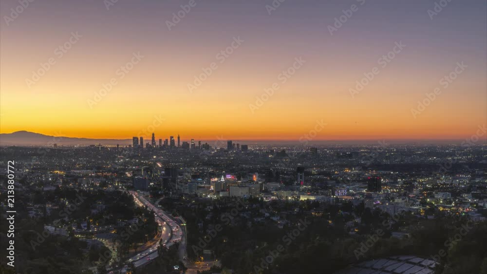 Timelapse of busy Los Angeles traffic with an orange sunrise over the cityscape Timelapse of busy Los Angeles traffic with an orange sunrise over the cityscape