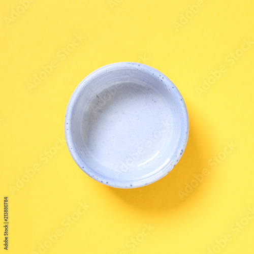 Blue dish isolated on yellow background