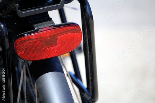 Close up of a wrought iron chair, with other similar chairs and tables in the out of focus background on a lovely sunny day