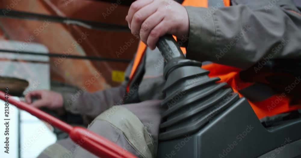 The worker manages the excavator. The worker manages the excavator.