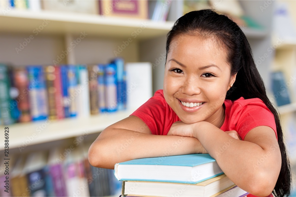 Young woman college student and stack book Young woman college student and stack book
