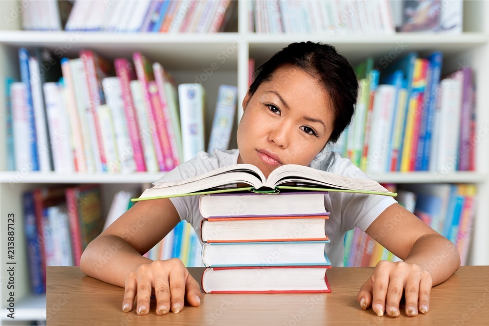 Young woman college student and stack book Young woman college student and stack book