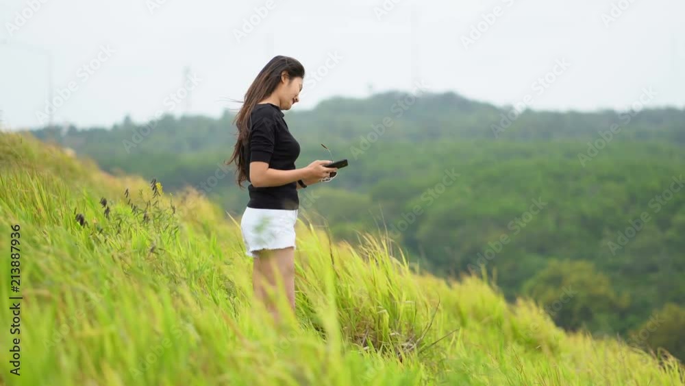 Asian women happily standing on the green fields. Asian women happily standing on the green fields.
