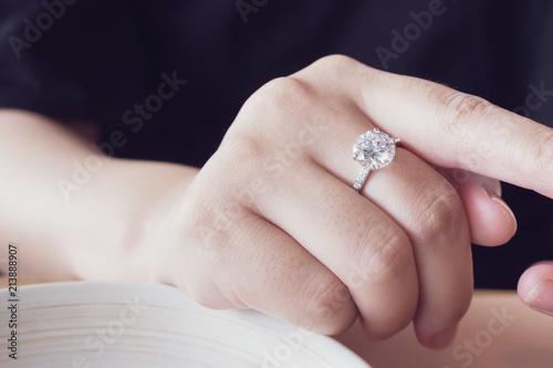 engagement diamond ring on woman finger closeup