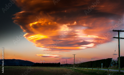 Spectacular lenticular clouds turn fiery and vibrant at sunset