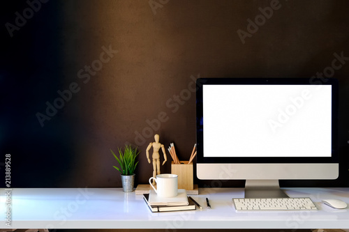 Workspace with modern desktop computer and creative gadgets on table.