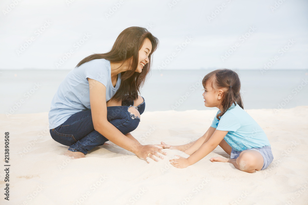 Asia mother playing with daughter on the beach. Asia mother playing with daughter on the beach.