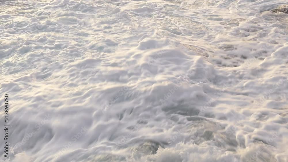 Close-up view of white wash breaking wave after hitting rock coastline. Close-up view of white wash breaking wave after hitting rock coastline.