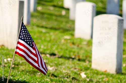 American flag in the foreground of military graves.