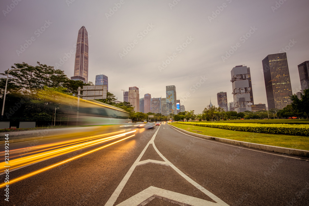 urban city road with motion bus at twilight, china.