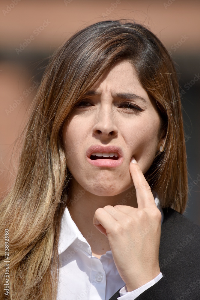 Adult Colombian Business Woman With Toothache Wearing Suit