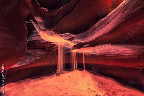 Waterfall effect created by falling sand from rocks in Antelope Canyon, Arizona, USA