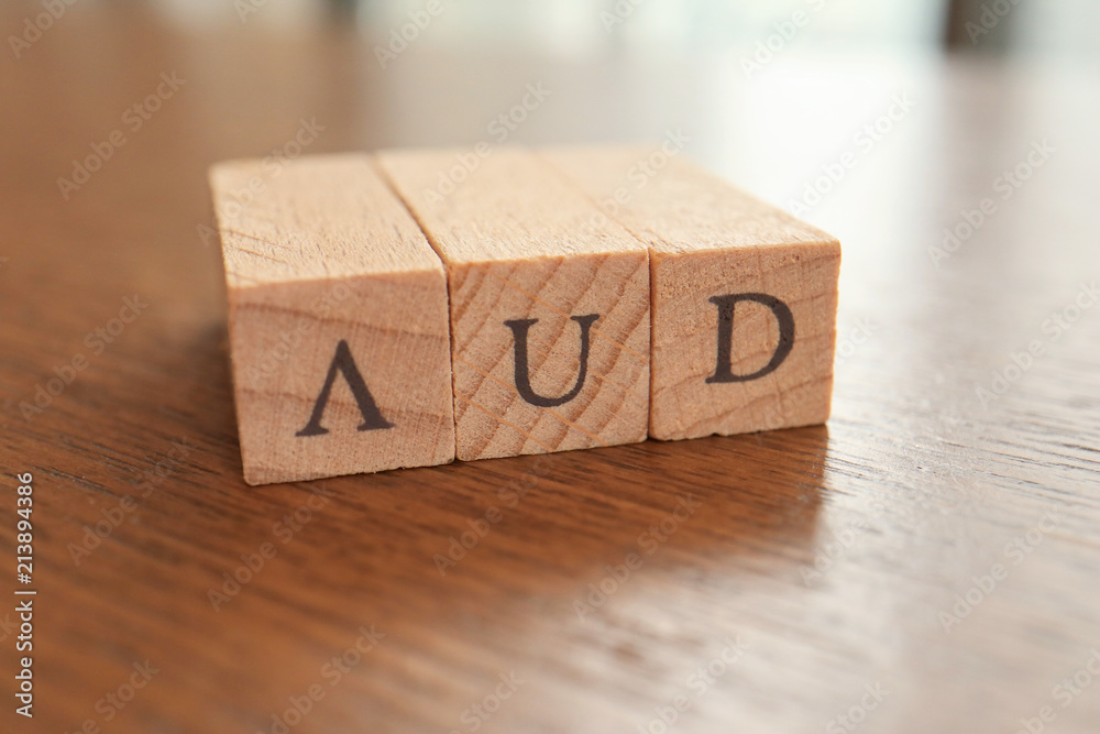 AUD (Australian Dollar) Text Block on Wooden Table AUD (Australian Dollar) Text Block on Wooden Table