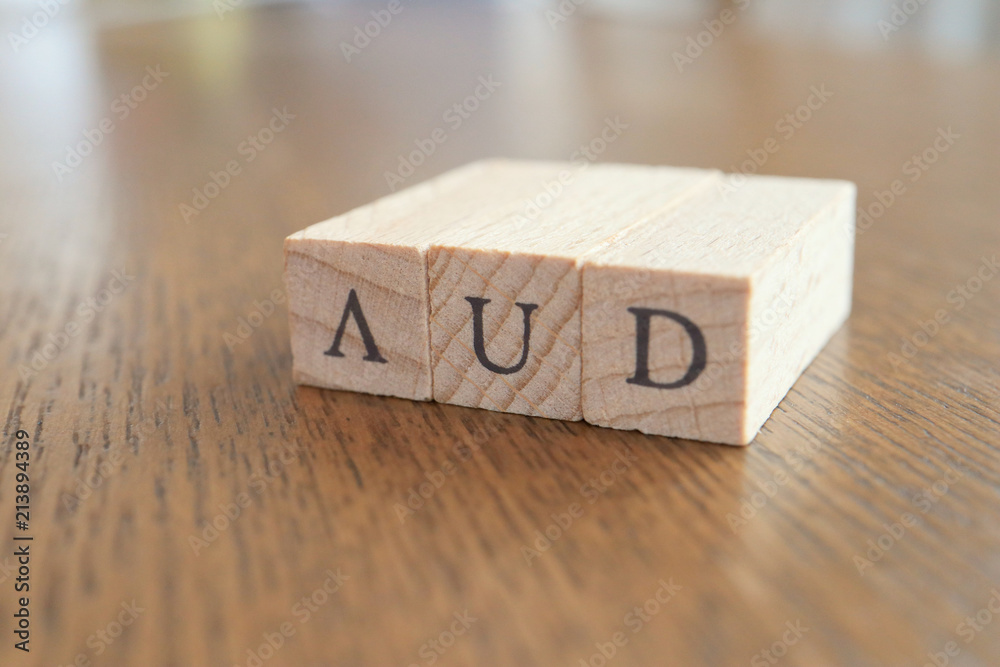AUD (Australian Dollar) Text Block on Wooden Table AUD (Australian Dollar) Text Block on Wooden Table