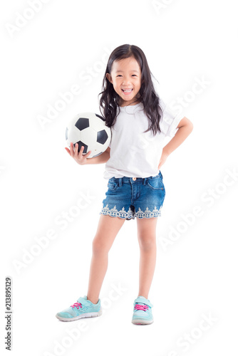 Young asian girl holding ball and smiles over white background