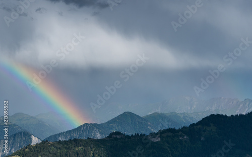 mountain landscape after a summer thunderstorm with a rainbow