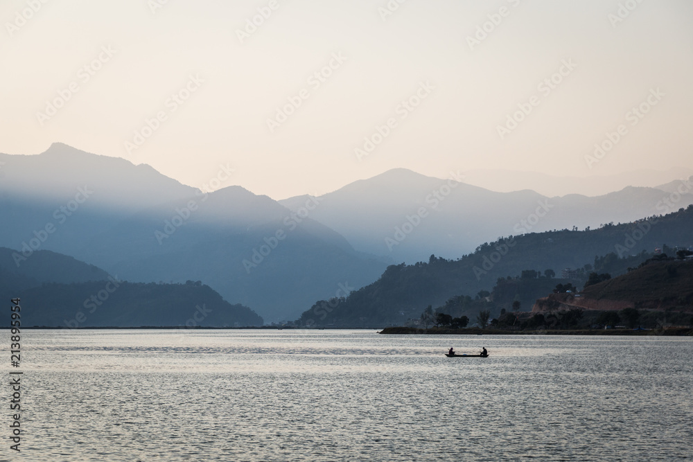 Sunset over the stunning Phewa lake in Pokhara at the feet of the Himalayas mountain in Nepal