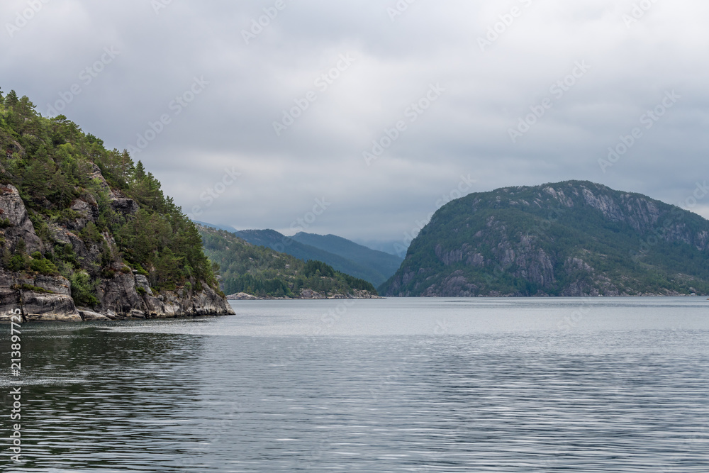 View of the fjord Monstraumen on a cloudy day. Monstraumen, Hordaland country, Norway, Europe. View of the fjord Monstraumen on a cloudy day. Monstraumen, Hordaland country, Norway, Europe.