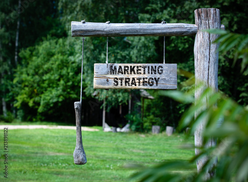 Marketing Strategy concept. inscription on a wooden announcment board outdoars at countryside photo