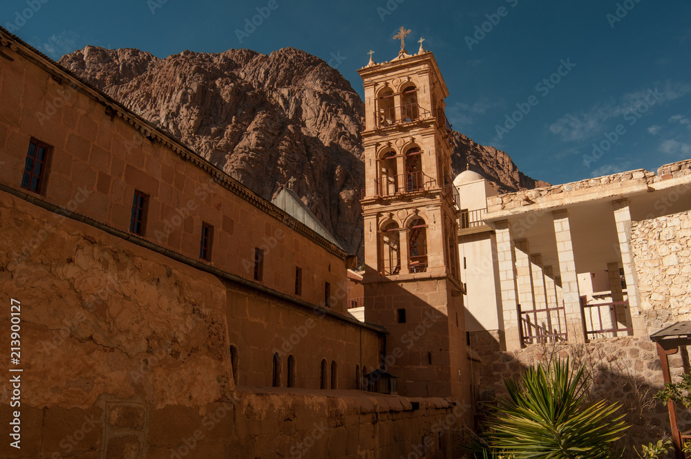 Fototapeta premium Temple tower, stone wall near the hill