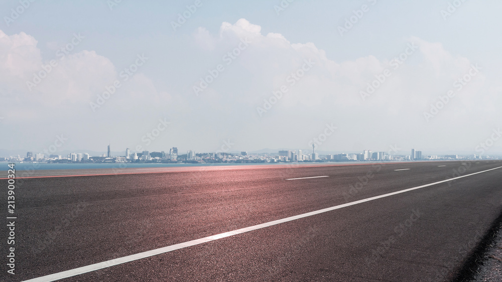 Fototapeta premium Empty road asphalt with panoramic cityscape