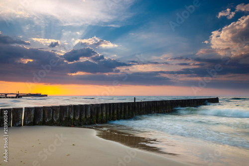 Sunset on the beach with breakwater  long time exposure