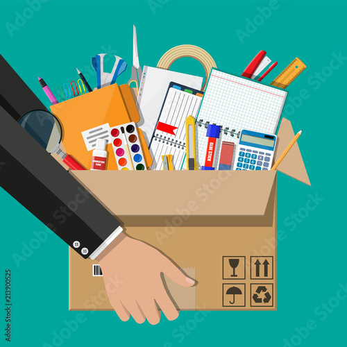 Office accessories in cardboard box in hand.
