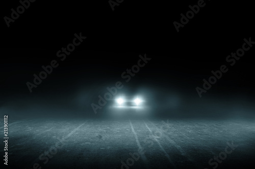 The lonely road at night with the car running. photo
