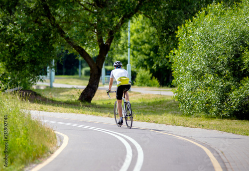 Wallpaper Mural Cyclist ride on the bike path in the city Park  Torontodigital.ca