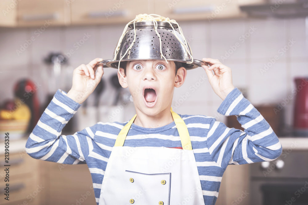 Funny little boy chef has a kitchen accident Stock Photo Adobe Stock