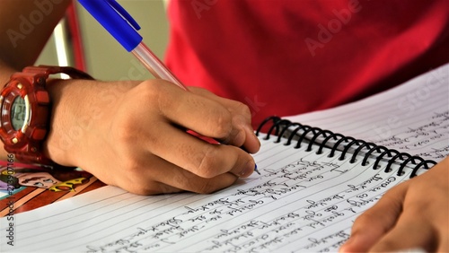 A girl writing gratitude on a pad.