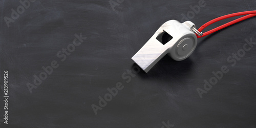 Fotografija Coach whistle with red string isolated on school blackboard background, copy space