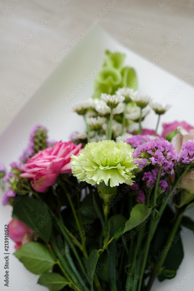 pink bouquet of carnations and roses. bouquet of flowers indoor in flower shop. Close up. Top view. Mother's Day and Valentine's Day concept pink bouquet of carnations and roses. bouquet of flowers indoor in flower shop. Close up. Top view. Mother's Day and Valentine's Day concept