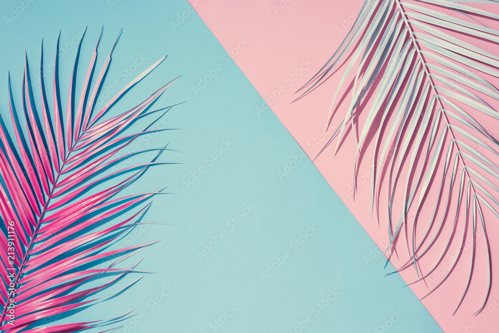 Tropical bright colorful background with exotic painted tropical palm leaves. Minimal fashion summer concept. Flat lay idea - obrazy, fototapety, plakaty 
