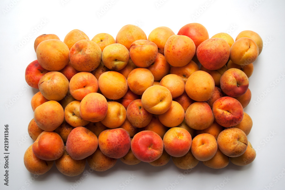 Heap of ripe apricots isolated on white background from a high angle view