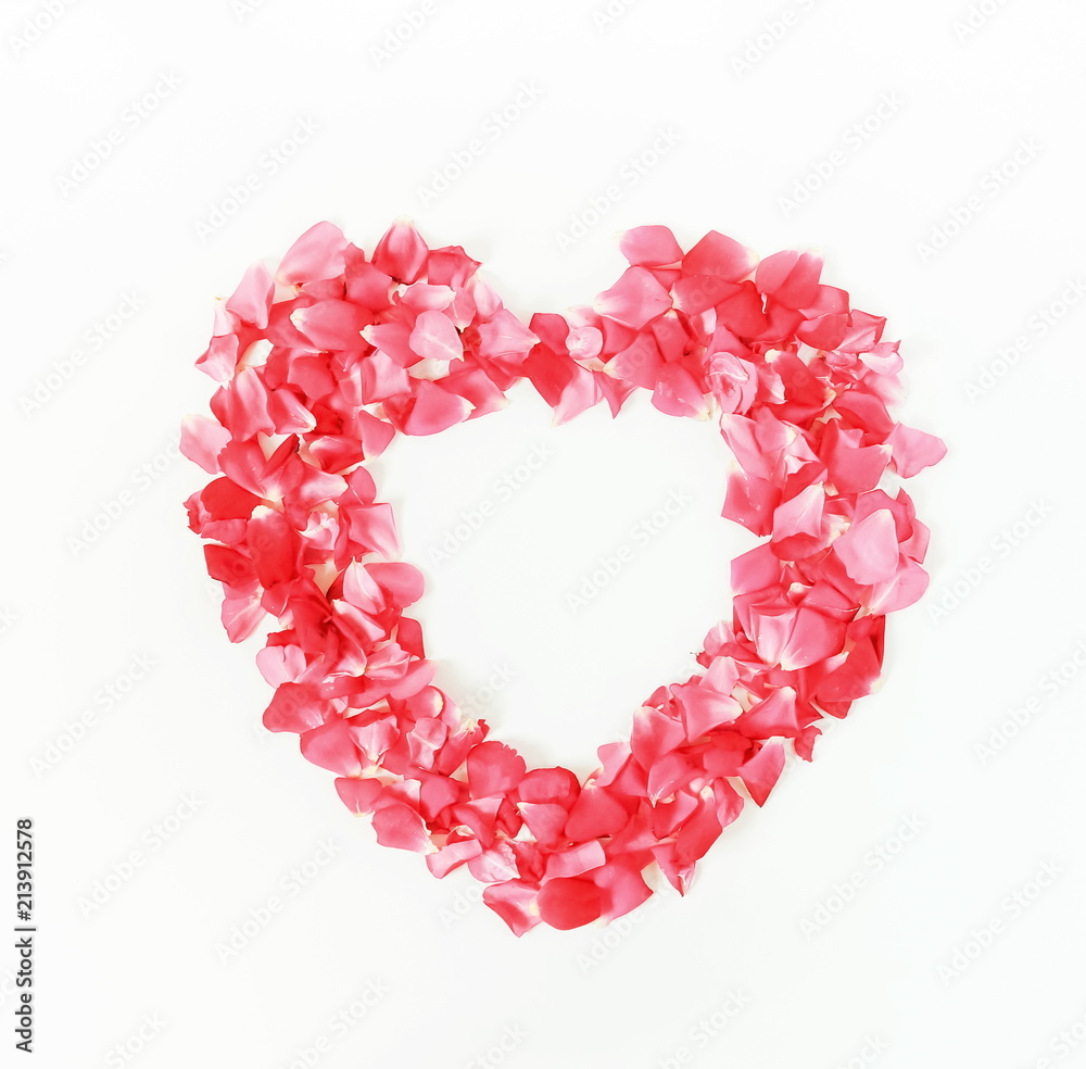 petals pattern of pink roses in the shape of heart on a white background. top view.copy space