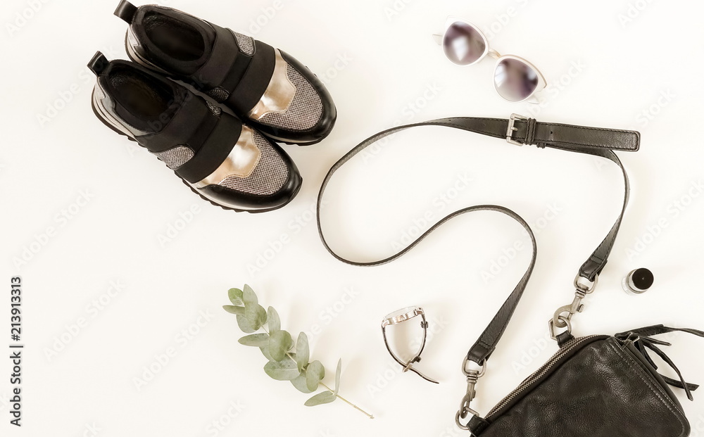 Obraz premium Woman casual fashion clothes and accessory set on white background. Bag, sneakers, sunglasses on white background. Flat lay, top view. Copy space
