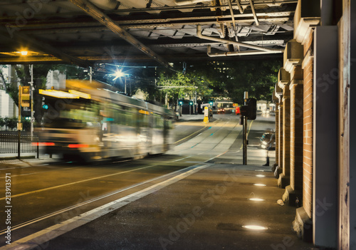 Melbourne tram passes under railway bridge