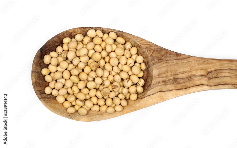 Organic raw soybeans in wooden spoon, isolated on white background, top view
