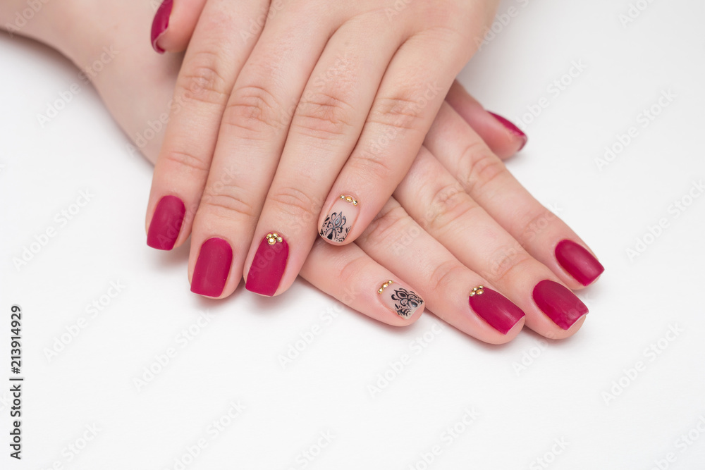 Closeup of hands of a young woman with red manicure on nails Closeup of hands of a young woman with red manicure on nails