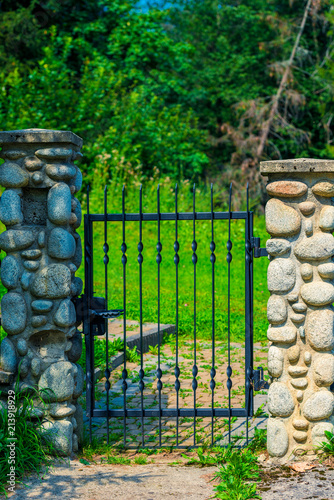 architectural element - wrought iron wicket and pillars trimmed with decorative stone