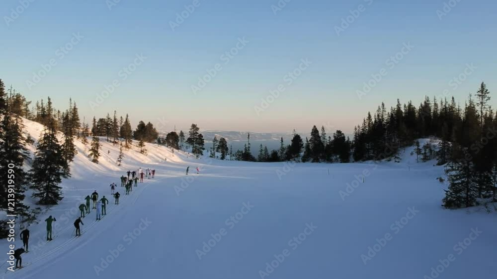 Drone hovering over a Cross Country skiing mass-start. A classic race called Markatrimmen in Trondheim's forrest Bymarka Drone hovering over a Cross Country skiing mass-start. A classic race called Markatrimmen in Trondheim's forrest Bymarka