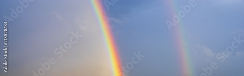 double, beautiful, multi-colored rainbow after passing a spring downpour