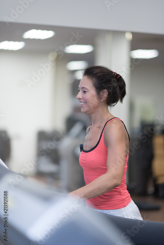Side view of attractive sport woman on running track. Girl on treadmill Free Download Side view of attractive sport woman on running track. Girl on treadmill - GFXLoad