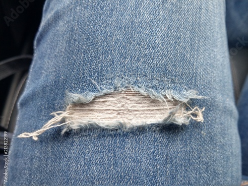 fashion background leg of woman in blue jean pants with torn